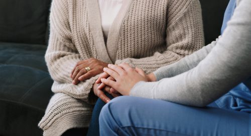 Give me your hand, we’ll get through this together Cropped shot of a nurse holding hands with a senior woman in a nursing home