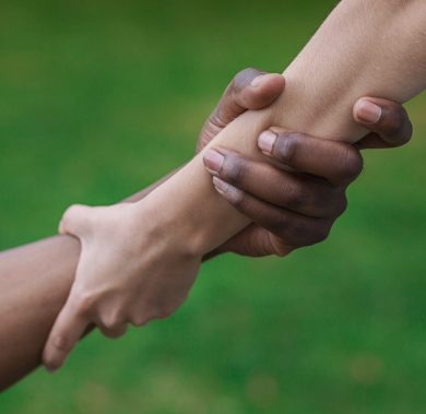 Multiethnic friends helping hand outdoor, copy space