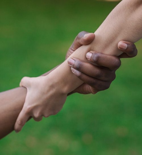 Multiethnic friends helping hand outdoor, copy space